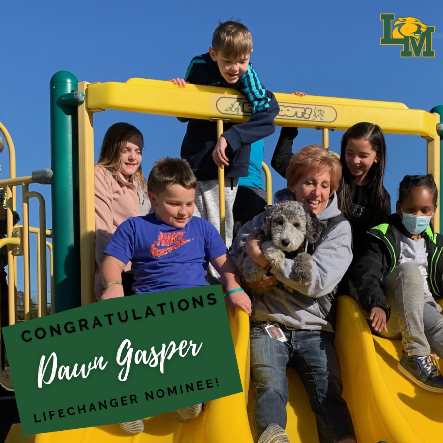 counselor and therapy dog go down slide with students